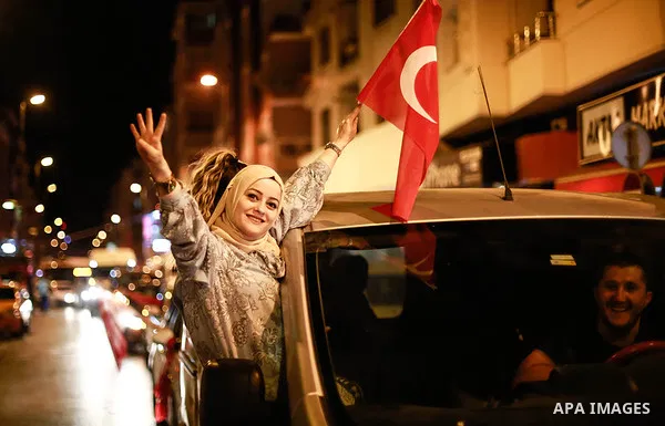 A picture taken on June 24, 2018 shows Supporters of Turkish President Recep Tayyip Erdogan celebrate the results of the Turkish presidential and parliamentary elections, in Istanbul, Turkey. Photo by Shady al-Assar