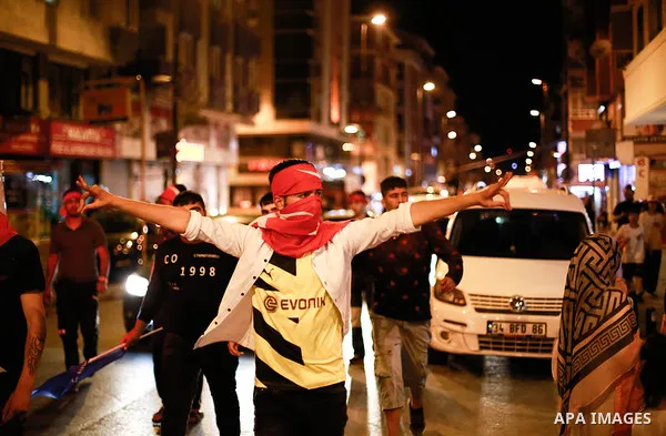 A picture taken on June 24, 2018 shows Supporters of Turkish President Recep Tayyip Erdogan celebrate the results of the Turkish presidential and parliamentary elections, in Istanbul, Turkey. Photo by Shady al-Assar