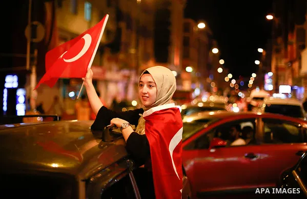 A picture taken on June 24, 2018 shows Supporters of Turkish President Recep Tayyip Erdogan celebrate the results of the Turkish presidential and parliamentary elections, in Istanbul, Turkey. Photo by Shady al-Assar