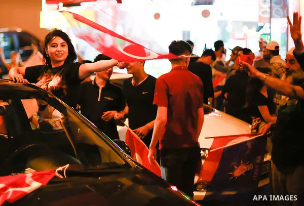 A picture taken on June 24, 2018 shows Supporters of Turkish President Recep Tayyip Erdogan celebrate the results of the Turkish presidential and parliamentary elections, in Istanbul, Turkey. Photo by Shady al-Assar