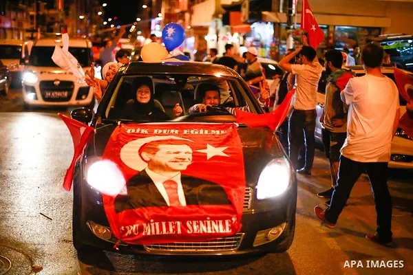 A picture taken on June 24, 2018 shows Supporters of Turkish President Recep Tayyip Erdogan celebrate the results of the Turkish presidential and parliamentary elections, in Istanbul, Turkey. Photo by Shady al-Assar