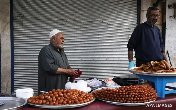 Syrians shop at market during the holy fasting month of Ramadan, in Azaz city, north of Aleppo, Syria, on May 3, 2020. Muslims around the world celebrate the holy month of Ramadan by praying during the night time and abs...