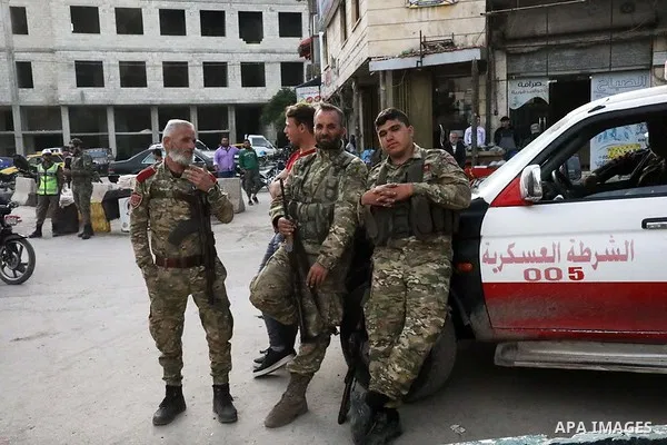 Syrian security stand guard at a market during the holy fasting month of Ramadan, in Azaz city, north of Aleppo, Syria, on May 3, 2020. Muslims around the world celebrate the holy month of Ramadan by praying during the n...
