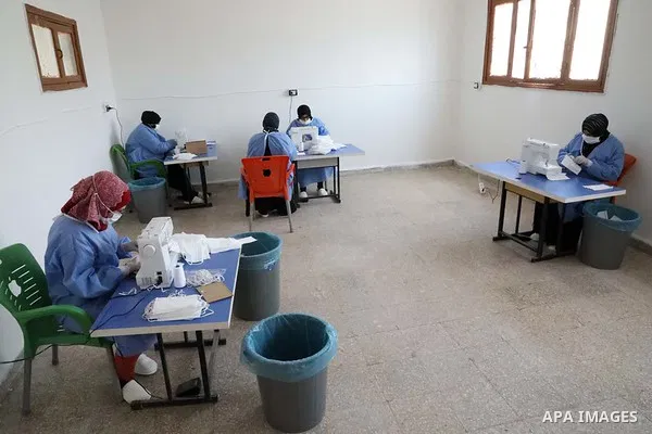 Syrian women sew protective masks at a factory in Azaz city, north of Aleppo, Syria, on May 4, 2020. Production of preventive medical suits in factories has increased recently as a precaution, amid concerns over the spre...