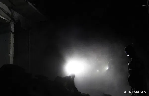 Syrian rescue workers search under the debris of a building following a reported bomb barrel attack by Syrian government forces, in Karm el-Beik rebel held district in the northern Syrian city of Aleppo, June 7, 2015. At...