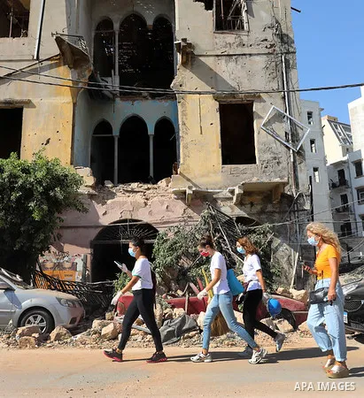 Lebanese walk beside the rubble near the site of blast in Beirut's port area, Lebanon August 6, 2020, three days after a massive explosion shook the Lebanese capital. Photo by Haitham Moussawi