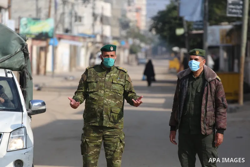 Members of Palestinian National Security Forces loyal to Hamas wear face masks, stand guard during a complete closure amid the spread of the Coronavirus COVID-19, in Deir al-Balah, central of Gaza Strip, on January 1, 20...
