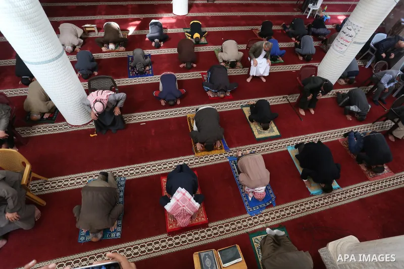 Palestinian Muslim worshippers wearing face masks prayer in a mosque as the holy places reopen to worshipers to perform the weekly Islamic ritual, amid concern about the spread of the coronavirus disease (COVID-19), in D...