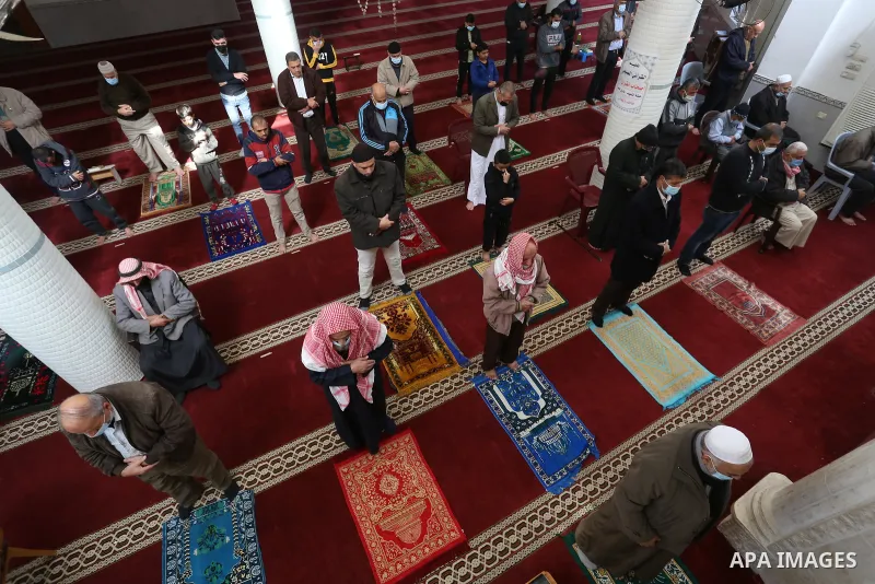 Palestinian Muslim worshippers wearing face masks prayer in a mosque as the holy places reopen to worshipers to perform the weekly Islamic ritual, amid concern about the spread of the coronavirus disease (COVID-19), in D...