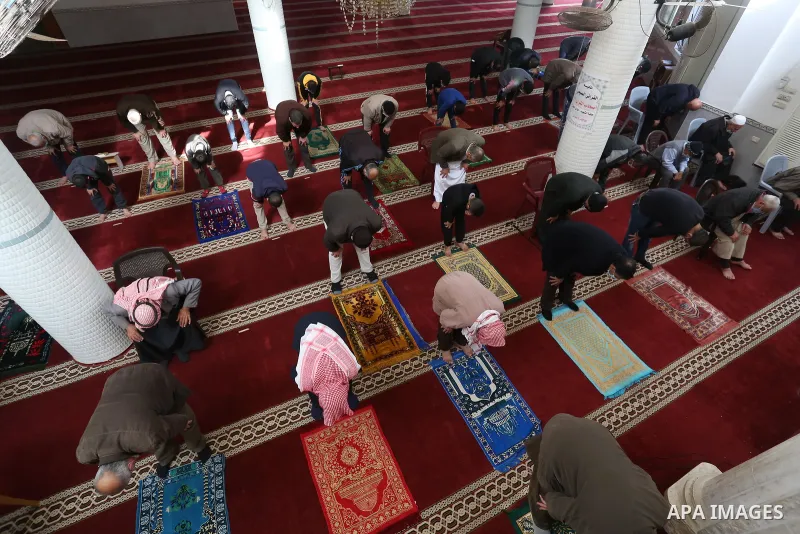 Palestinian Muslim worshippers wearing face masks prayer in a mosque as the holy places reopen to worshipers to perform the weekly Islamic ritual, amid concern about the spread of the coronavirus disease (COVID-19), in D...