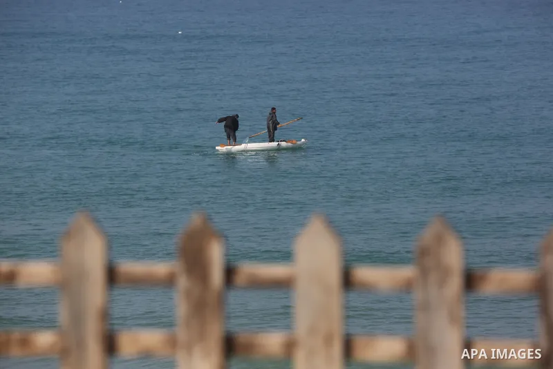 Palestinians fisherman ride their boat in Mediterranean Sea amid concern about the spread of the coronavirus disease (COVID-19), in Deir al-Balah, central of Gaza Strip, on January 10, 2021. Photo by Ashraf Amra