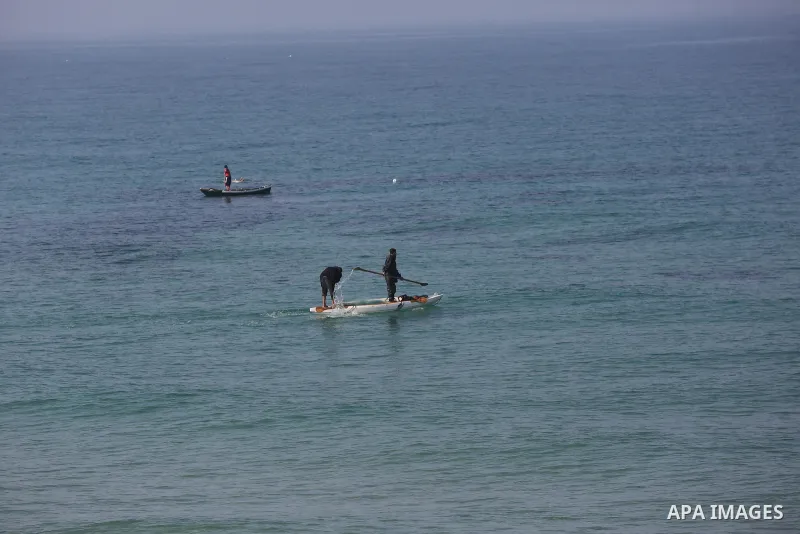 Palestinians fisherman ride their boat in Mediterranean Sea amid concern about the spread of the coronavirus disease (COVID-19), in Deir al-Balah, central of Gaza Strip, on January 10, 2021. Photo by Ashraf Amra