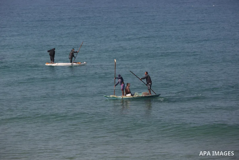 Palestinians fisherman ride their boat in Mediterranean Sea amid concern about the spread of the coronavirus disease (COVID-19), in Deir al-Balah, central of Gaza Strip, on January 10, 2021. Photo by Ashraf Amra