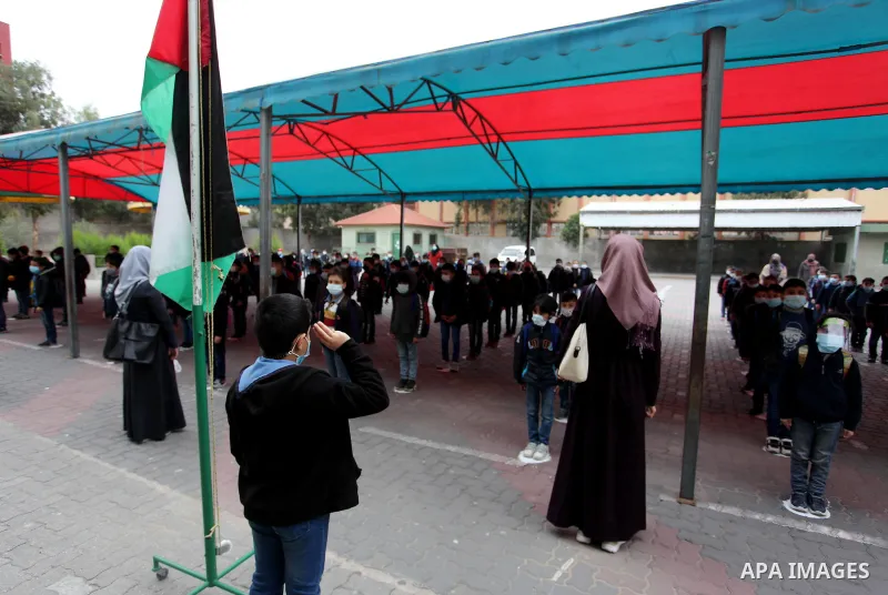 Palestinian students wearing protective face masks, participate in a morning activity as schools gradually reopen amid the coronavirus disease (COVID-19) outbreak, at their school in Gaza city on January 13, 2021. In a w...