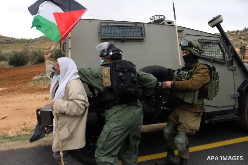 Members of the Israeli forces detain a Palestinian protesters during a protest against the Israeli army and settler attacks targeting the area’s Palestinian residents, in Yatta village in the southern West bank City of H...