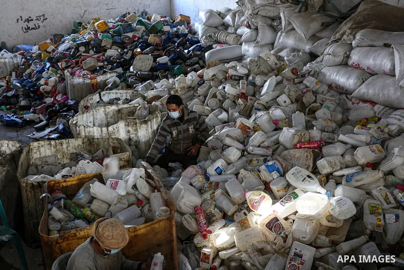 Palestinian workers reuses plastic to produce water hoses and toys for childrenat a factory, in Khan Younis in the southern Gaza Strip on January 18, 2021. According to the most recent November UNCTAD report (2020), Gaza...