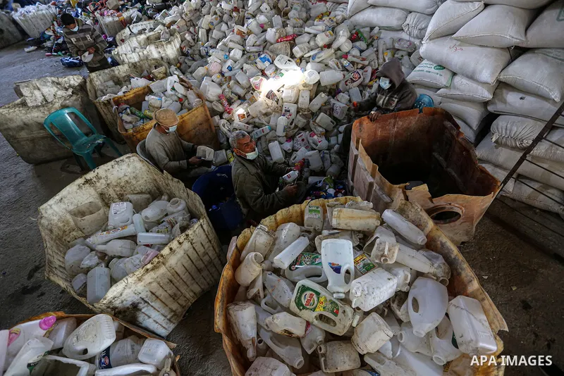 Palestinian workers reuses plastic to produce water hoses and toys for childrenat a factory, in Khan Younis in the southern Gaza Strip on January 18, 2021. According to the most recent November UNCTAD report (2020), Gaza...