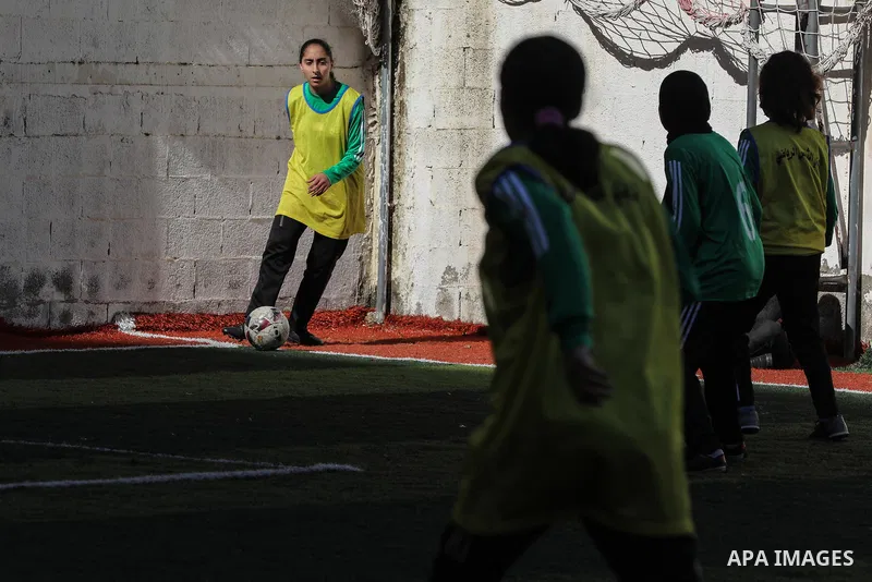 Palestinian girls take part in a local football competition in Gaza City January 21, 2021. Women's association football, usually known as women's football or women's soccer, and colloquially WOSO, is the team sport of as...
