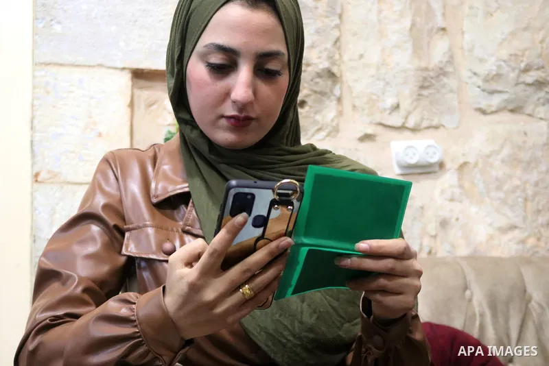 Members of the Palestinian Abu Shamsiyeh family register to vote through the Palestinian Elections Committee website, at home in the West Bank city of Hebron, on January 22, 2021. The Palestinian presidency announced on...