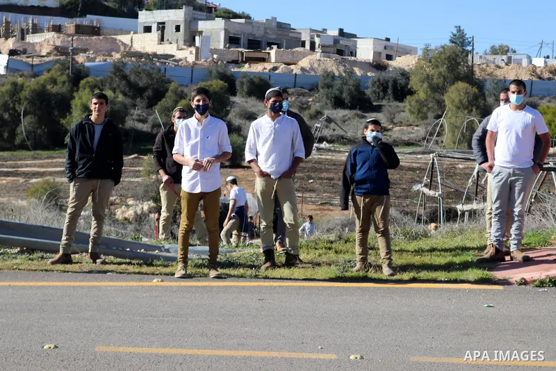 Foreign activists argue with Israeli soldiers during a protest against the Israeli army and settler attacks targeting the area’s Palestinian residents, in Yatta village in the southern West bank City of Hebron on January...