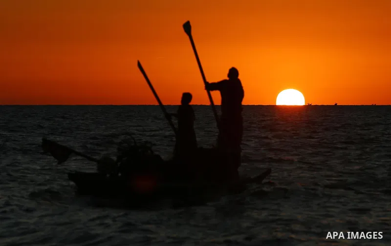 Palestinians fishermen ride their boat in Mediterranean Sea after the coronavirus disease (COVID-19) restrictions eased, in Deir Al-Balah in the center of the Gaza Strip on January 23, 2021, the Ministry of Interior anno...