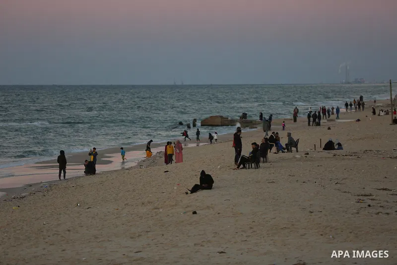 Palestinians enjoy their time on the beach after the coronavirus disease (COVID-19) restrictions eased, in Deir Al-Balah in the center of the Gaza Strip on January 23, 2021, the Ministry of Interior announced a series of...