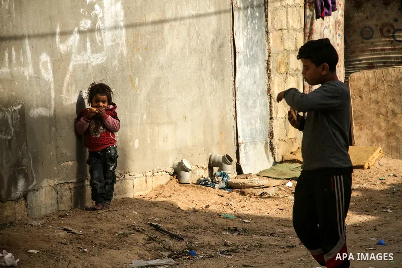 Palestinian children play outside their home, in Beit Lahia in the northern Gaza Strip, on January 26, 2021. Gaza suffered shortages of water, medicine and power, a situation exacerbated by the coronavirus crisis. "19 hu...