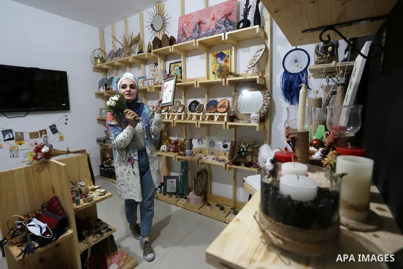 Two Palestinian graduates Haya Abu Daqqa and Areej Al-Saqa work in a gift and antiques store, in Khan Yunis in the southern Gaza Strip on January 28, 2021. Unemployment rate in the Gaza Strip is still among the highest i...