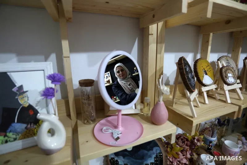 Two Palestinian graduates Haya Abu Daqqa and Areej Al-Saqa work in a gift and antiques store, in Khan Yunis in the southern Gaza Strip on January 28, 2021. Unemployment rate in the Gaza Strip is still among the highest i...