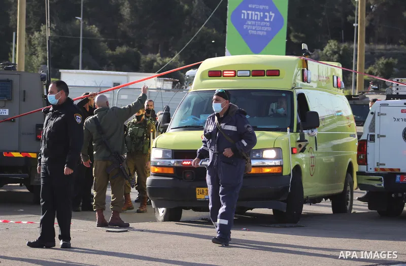 Members of Israeli security forces surround the body of a Palestinian man shot by Israeli security after reportedly attempting a knife attack, near the Israeli settlement of Gosh Etzion, north of Hebron city in the occup...