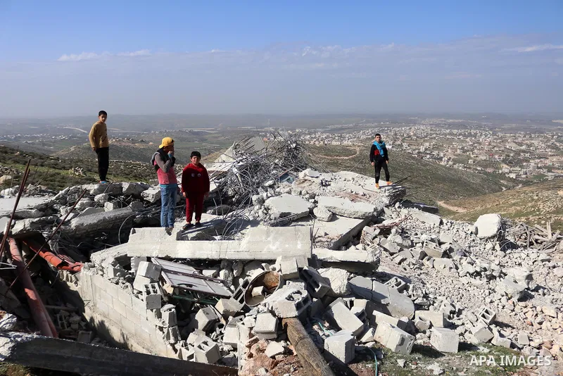 Palestinians inspect the rubble of houses which were demolished by the Israeli army under the pretext of illegal construction in the West Bank village of Dura, south of Hebron on February 4, 2021. he Israeli army demolis...
