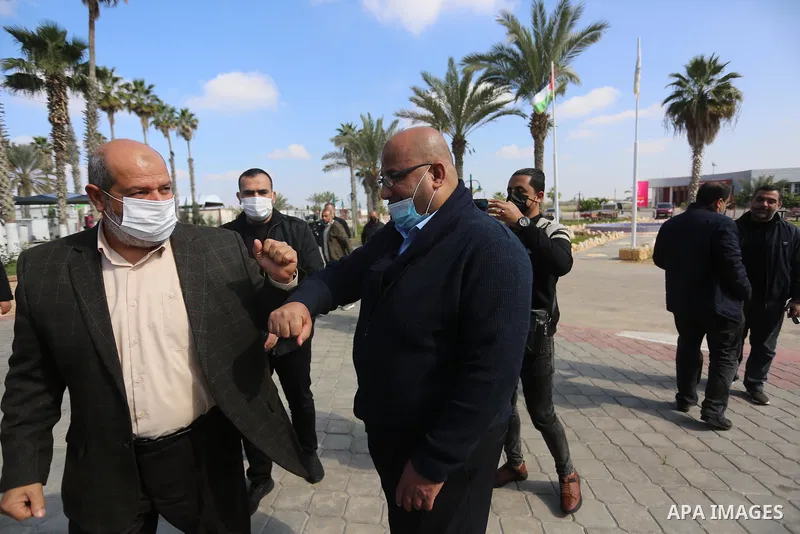 Members of the Palestinian factions are wait to cross into Egypt through the Rafah border crossing, in Rafah in the southern of Gaza Strip, on February 7, 2021. On Sunday, delegations belonging to different Palestinian f...
