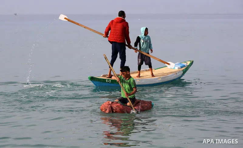 Palestinian fishermen ride their boat in Mediterranean Sea, amid the outbreak of the coronavirus disease (COVID-19), in Deir Al-Balah in the center of the Gaza Strip on February 8, 2021. In 2018 and early 2019, the Pales...