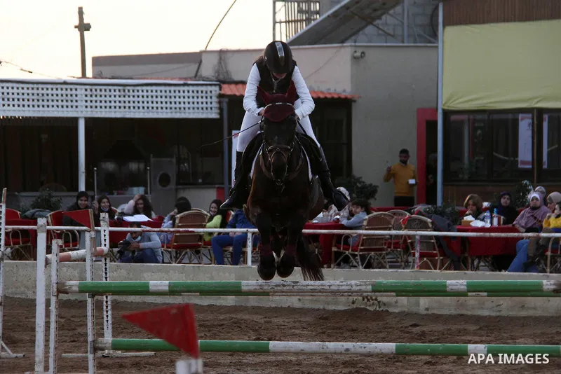 Palestinian competitors ride their horses during local show, amid the spread of the Coronavirus COVID-19, in Gaza City on February 09, 2021. Wearing riding pants, logo-decorated shirts and helmets, Gaza horse-riders resu...