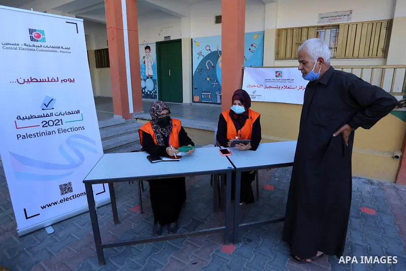 Palestinian members of Central Elections Commission register voters for the upcoming elections, in a school, in Khan Yunis in the southern Gaza Strip on February 10, 2021. Rival Palestinian factions Fatah and Hamas said...