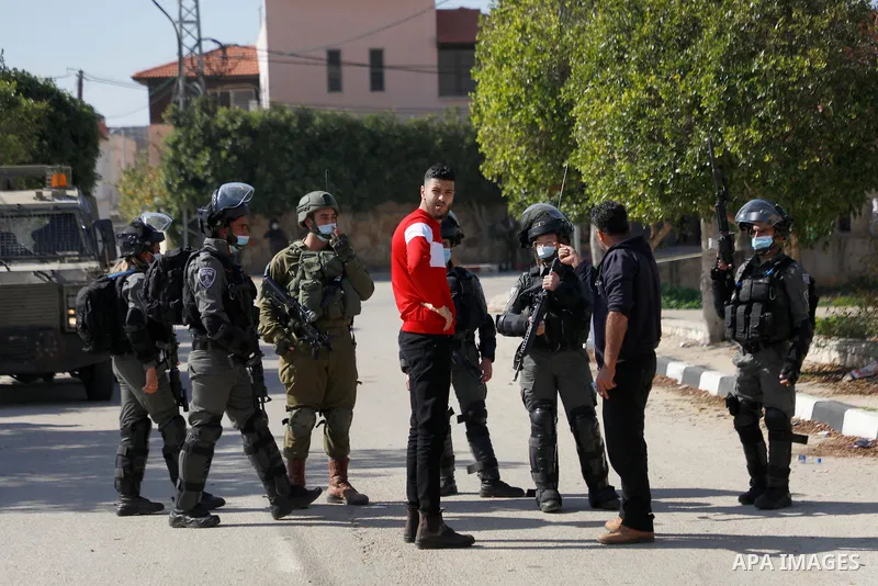 Israeli security forces stand guard near the house of Palestinian Mohammed Kabaha, who was allegedly accused by the Israeli occupation of killing an Israeli settler in late December 2020, as they prepare to blow it up, i...