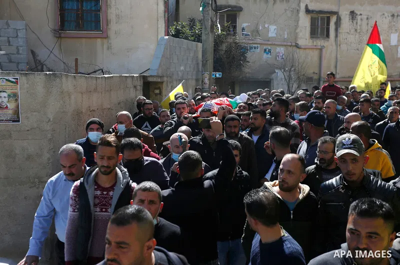 Palestinian mourners carry the body of Azzam Amer, during the funeral, in the West Bank village of Salfit, on February 11, 2021. A Palestinian was killed today evening after he was deliberately run over by an Israeli set...