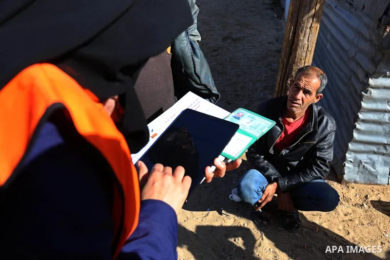 Palestinian members of Central Elections Commission register voters for the upcoming elections, at Nahr al-Bared refugee camp in Khan Younis in the southern Gaza Strip on February 11, 2021. Nahr Al-Bared is a marginalize...