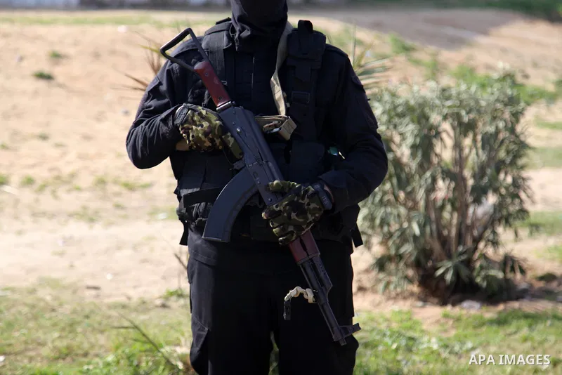 Palestinian militants from the Ezzedine al-Qassam Brigades, the armed wing of the Hamas movement attend the funeral of the leader Ibrahim Al-Yazuri,80, who died of the coronavirus (COVID-19) pandemicin, Gaza City on Febr...