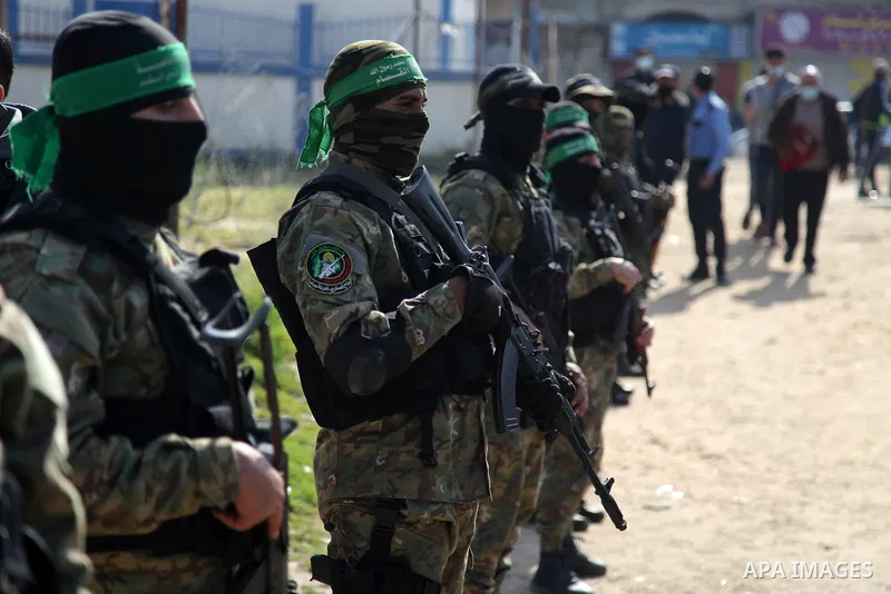 Palestinian militants from the Ezzedine al-Qassam Brigades, the armed wing of the Hamas movement attend the funeral of the leader Ibrahim Al-Yazuri,80, who died of the coronavirus (COVID-19) pandemicin, Gaza City on Febr...