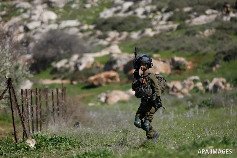 Israeli forces take position during a demonstration against the expansion of settlements, in Beit Dajan in the Israeli-occupied West Bank on February 12, 2021. The settler population in the West Bank has grown by around...