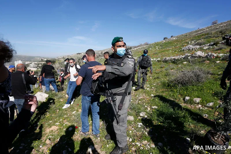 Israeli security forces assault foreign peace activists and Israelis while they planted olive trees in the lands of Burin village, south of Nablus in the West Bank on February 12, 2021. Israel has occupied the West Bank...