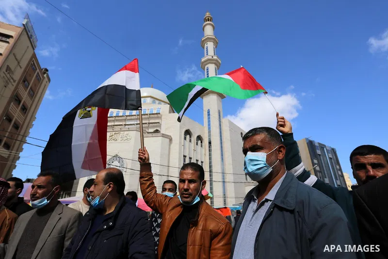 Palestinians wave the Egyptian flags during a rally to say "Thank" to Egypt for its support for Palestinian reconciliation, in Khan Younis in the southern of Gaza strip, on February 13, 2021. Palestinian factions agreed...