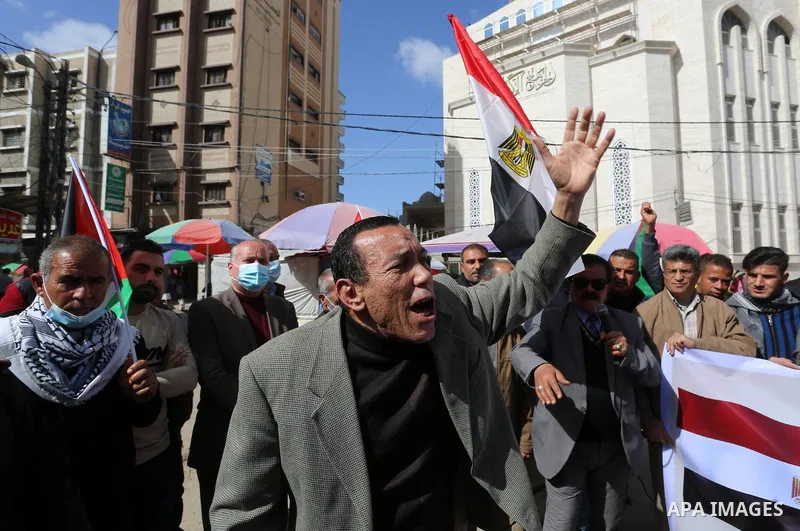 Palestinians wave the Egyptian flags during a rally to say "Thank" to Egypt for its support for Palestinian reconciliation, in Khan Younis in the southern of Gaza strip, on February 13, 2021. Palestinian factions agreed...