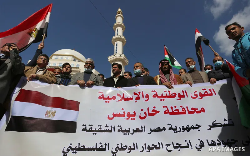 Palestinians wave the Egyptian flags during a rally to say "Thank" to Egypt for its support for Palestinian reconciliation, in Khan Younis in the southern of Gaza strip, on February 13, 2021. Palestinian factions agreed...