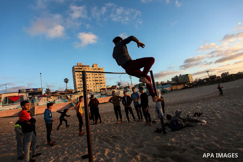 Palestinian youths demonstrate their parkour skills on the beach, amid the outbreak of the coronavirus disease (COVID-19), in Gaza city on February 12, 2021. Palestine is going to be Sunny with a maximum temperature of 2...
