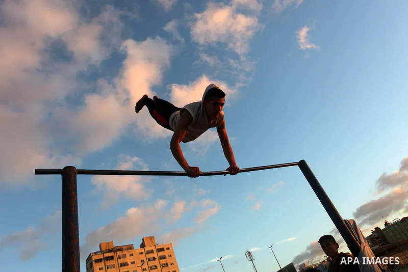 Palestinian youths demonstrate their parkour skills on the beach, amid the outbreak of the coronavirus disease (COVID-19), in Gaza city on February 12, 2021. Palestine is going to be Sunny with a maximum temperature of 2...