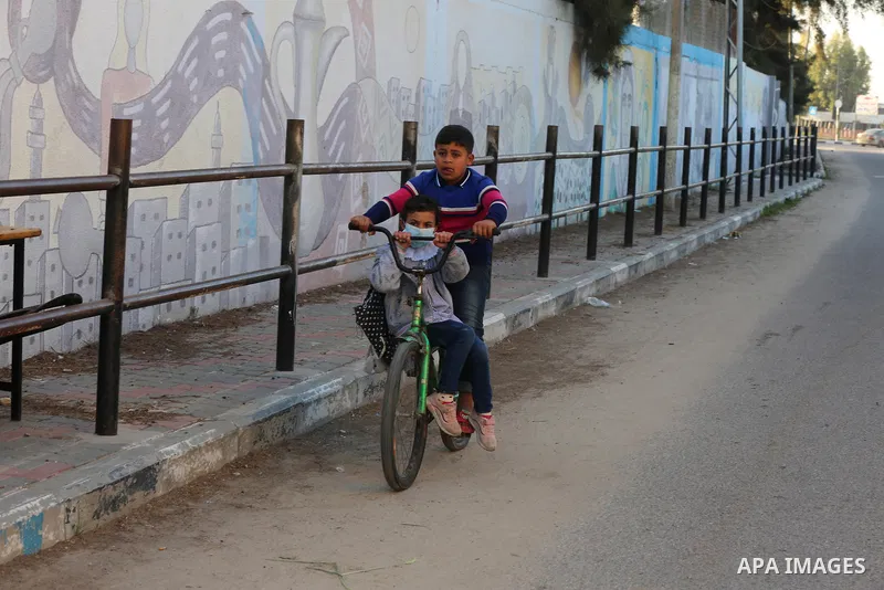 Palestinian students wearing protective face masks, as schools gradually reopen amid the coronavirus disease (COVID-19) outbreak, at their school run by the United Nations Relief and Works Agency (UNRWA) in Deir al-Balah...