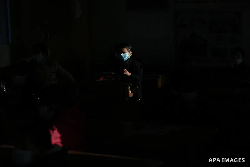 Palestinian students wearing protective face masks, as schools gradually reopen amid the coronavirus disease (COVID-19) outbreak, at their school run by the United Nations Relief and Works Agency (UNRWA) in Deir al-Balah...