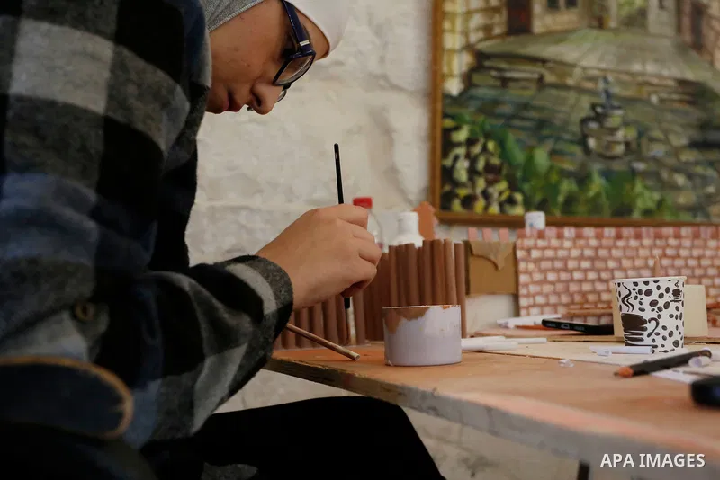 Palestinian engineer, Nora Jardaneh, works on rebuilding three models of Nablus in different periods of time, in the West Bank City of Nablus, on February 15, 2021. The sculptures embody the Roman time and the first city...